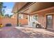 The brick paved back patio offers a cozy space with seating and shade for outdoor enjoyment at 744 Forest Peak St, Henderson, NV 89011
