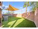 Lush backyard with artificial turf, a trampoline, and ample space for outdoor activities at 744 Forest Peak St, Henderson, NV 89011