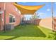 Backyard with green lawn, playground set, and shade structure creates the perfect Gathering space at 744 Forest Peak St, Henderson, NV 89011