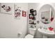 Charming powder room with Mickey Mouse themed decor and a pedestal sink at 744 Forest Peak St, Henderson, NV 89011