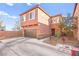 Two-story home featuring a brown garage door and tastefully landscaped yard with desert-themed plants at 744 Forest Peak St, Henderson, NV 89011
