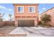 Two-story home featuring a brown garage door and tasteful desert-themed landscaping at 744 Forest Peak St, Henderson, NV 89011