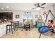 Well-lit kitchen and eating area with tile flooring, featuring a table and chairs, and modern appliances at 744 Forest Peak St, Henderson, NV 89011