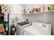 Functional laundry area features a washer, dryer, storage shelves, and cleaning supplies for added convenience at 744 Forest Peak St, Henderson, NV 89011
