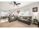 Open-concept living room featuring comfortable seating, ceiling fan, and bright, neutral-toned walls at 744 Forest Peak St, Henderson, NV 89011