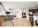 Open-concept living space with kitchen featuring modern appliances flowing into living room with plush sofa and TV at 744 Forest Peak St, Henderson, NV 89011