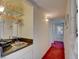 Hallway wet bar featuring glass shelving, sink and wine glasses at 750 S Royal Crest Cir # 345, Las Vegas, NV 89169