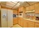 Charming kitchen with wood cabinetry, a white refrigerator, and a range with classic vent hood at 750 S Royal Crest Cir # 345, Las Vegas, NV 89169