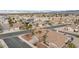 Street view of single story homes with palm trees, desert landscaping, and tile roofs at 802 Blue Springs Dr, Henderson, NV 89002