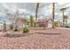 Well-maintained single-story home featuring desert landscaping and mature palm trees in front yard at 802 Blue Springs Dr, Henderson, NV 89002