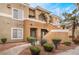Exterior angle of 2-story complex with tidy landscaping and a clear address marker at 8070 W Russell Rd # 2015, Las Vegas, NV 89113