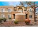 Condominium exterior showcasing a tan facade and well-maintained landscaping at 8070 W Russell Rd # 2015, Las Vegas, NV 89113