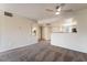 Bright and airy living room with carpeting, updated light fixture, and kitchen view at 8070 W Russell Rd # 2015, Las Vegas, NV 89113
