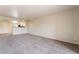 A spacious living room features neutral carpet, paint, and ceiling fan for comfort at 8070 W Russell Rd # 2015, Las Vegas, NV 89113