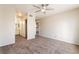 A bedroom with neutral walls, carpet, a ceiling fan, closet, and adjacent bathroom at 8070 W Russell Rd # 2015, Las Vegas, NV 89113