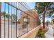 A fenced community pool area featuring a pool house, tables, and a serene swimming pool at 8070 W Russell Rd # 2015, Las Vegas, NV 89113