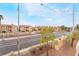 A sunny street view capturing the neighborhood's landscaped greenery and condo building architecture at 8070 W Russell Rd # 2015, Las Vegas, NV 89113