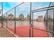 Outdoor tennis court with a view of the surrounding community, secured by a chain-link fence and gate at 8070 W Russell Rd # 2015, Las Vegas, NV 89113