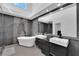 Luxurious bathroom with a soaking tub, double vanity, and high-end finishes at 8170 Round Hills Cir, Las Vegas, NV 89113