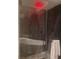 Contemporary bathroom features a soaking tub and red rainfall shower head at 8170 Round Hills Cir, Las Vegas, NV 89113