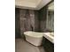 Bathroom offers luxurious soaking tub, dark accent wall, and modern fixtures at 8170 Round Hills Cir, Las Vegas, NV 89113