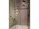 Modern tiled shower features a rainfall shower head, handheld sprayer and built-in shelving at 8170 Round Hills Cir, Las Vegas, NV 89113