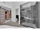 Modern bathroom featuring a glass-enclosed shower, soaking tub, and stylish tile work at 8170 Round Hills Cir, Las Vegas, NV 89113