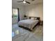 Cozy bedroom features marble floors, a modern bed frame, and bright natural light at 8170 Round Hills Cir, Las Vegas, NV 89113
