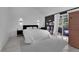 Serene bedroom with black accent wall, luxury vinyl floors, and access to the outdoors at 8170 Round Hills Cir, Las Vegas, NV 89113