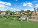 Upscale homes overlook lush green golf course with water features, mature trees, and vibrant landscaping at 8170 Round Hills Cir, Las Vegas, NV 89113