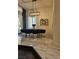 Well lit dining room features a modern light fixture, decorative wall art and tile flooring at 8170 Round Hills Cir, Las Vegas, NV 89113