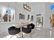 Elegant dining area featuring modern lighting fixture, and views to the kitchen at 8170 Round Hills Cir, Las Vegas, NV 89113