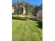 Charming exterior view featuring lush green lawn and mature trees at 8170 Round Hills Cir, Las Vegas, NV 89113
