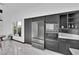 Modern kitchen featuring stainless steel appliances, dark cabinetry, and bright, airy atmosphere at 8170 Round Hills Cir, Las Vegas, NV 89113