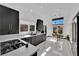 Stylish kitchen with sleek black cabinets, quartz countertops, and stainless steel appliances at 8170 Round Hills Cir, Las Vegas, NV 89113