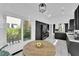 Bright kitchen with black cabinets, gold hardware, and a cozy breakfast nook with round wooden table at 8170 Round Hills Cir, Las Vegas, NV 89113