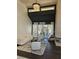 Bright, high-ceiling living room with modern chandelier and outdoor view at 8170 Round Hills Cir, Las Vegas, NV 89113