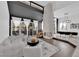 Bright, open living area with fireplace, white walls, and large windows with backyard views at 8170 Round Hills Cir, Las Vegas, NV 89113