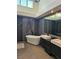 Spa-like main bathroom boasts a freestanding tub and double vanities at 8170 Round Hills Cir, Las Vegas, NV 89113