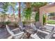 Cozy covered patio with seating around a fire pit, perfect for outdoor relaxation at 8170 Round Hills Cir, Las Vegas, NV 89113