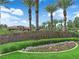 Entrance to Spanish Trail community showcasing manicured landscaping and palm trees at 8170 Round Hills Cir, Las Vegas, NV 89113
