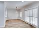 Bright dining room with wood floors, modern lighting fixture, and sliding glass doors at 821 Glacier Peak Ln # 203, Las Vegas, NV 89144