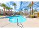 Beautiful community pool area surrounded by palm trees and landscaping at 821 Glacier Peak Ln # 203, Las Vegas, NV 89144