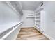 Well-organized walk-in closet with built-in shelving and laminate flooring, offering ample storage space at 821 Glacier Peak Ln # 203, Las Vegas, NV 89144