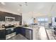 Modern kitchen features stainless steel appliances, granite countertops, and an island with seating at 8255 Las Vegas Blvd # 1504, Las Vegas, NV 89123