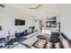 Open-concept living room featuring a leather sofa, area rug, and views into the kitchen at 8255 Las Vegas Blvd # 1504, Las Vegas, NV 89123