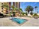 Community pool featuring a raised spa, lounge seating, and palm trees at 8255 Las Vegas Blvd # 1504, Las Vegas, NV 89123