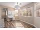 Bright dining area with built-in desk, tile floors, large windows, and modern lighting at 85 Green Isle Cir, Henderson, NV 89074