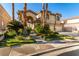 Striking two-story home highlighting a well-manicured lawn, mature trees, and an extended driveway at 85 Green Isle Cir, Henderson, NV 89074