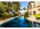 Enjoy this inviting pool with a basketball hoop, surrounded by lush landscaping and palm trees for ultimate relaxation at 85 Green Isle Cir, Henderson, NV 89074